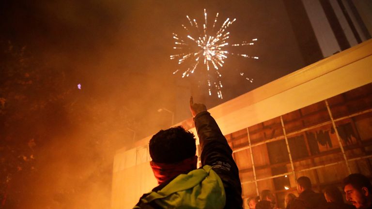 Fireworks explode as pro-Palestinian demonstrators gather near the Israeli Consulate during a protes