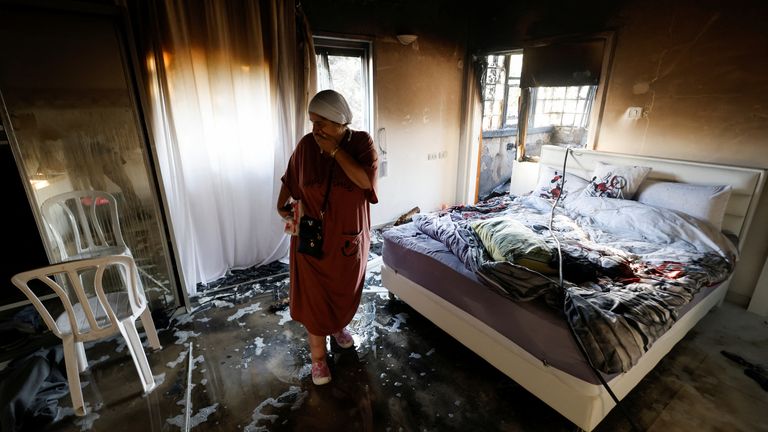 A woman stands in a damaged room after rockets were launched from the Gaza Strip, in Ashkelon, Israel October 7, 2023. REUTERS/Amir Cohen
