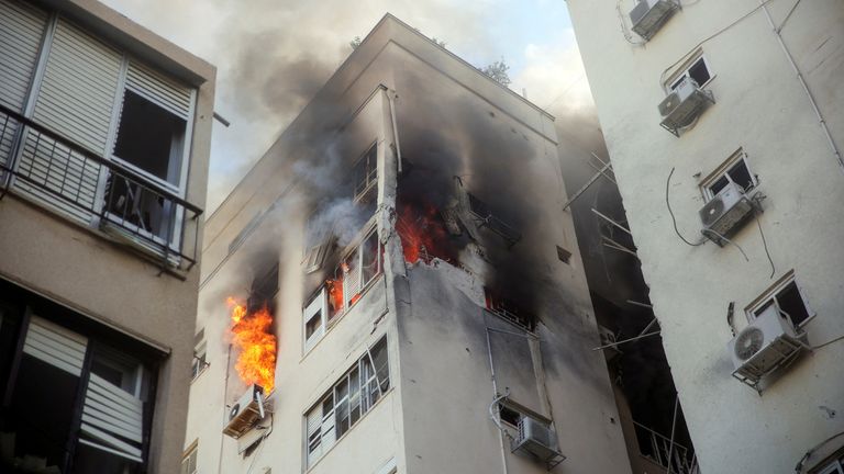 A building is ablaze following rocket attacks from the Gaza Strip, in Tel Aviv, Israel October 7, 2023. REUTERS/Itai Ron
