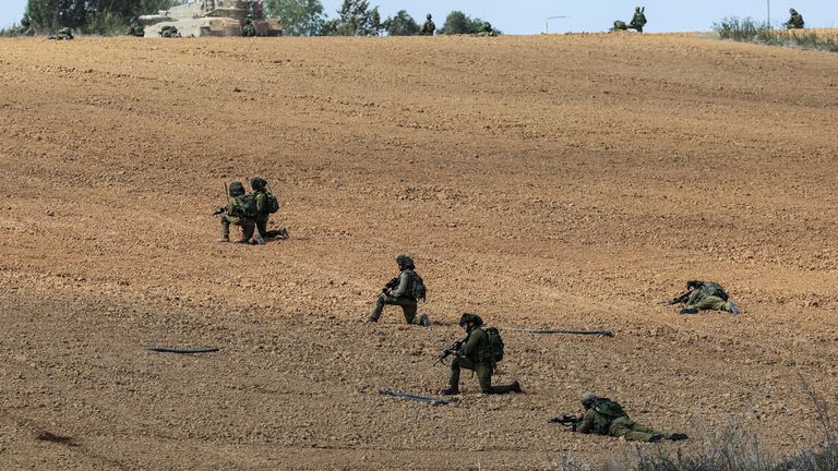 Israeli soldiers take position at Kibbutz Kfar Aza, in southern Israel, October 10, 2023. REUTERS/Ronen Zvulun