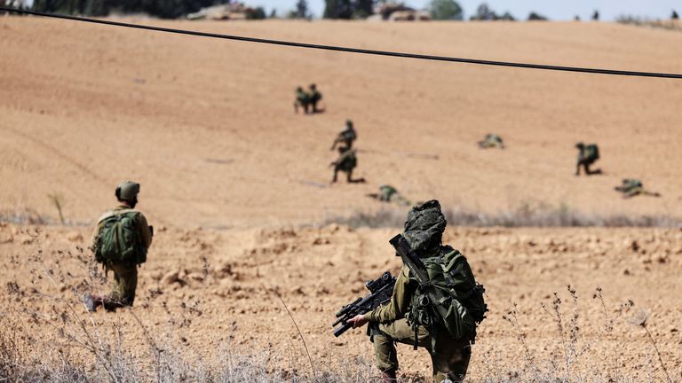Israeli soldiers take position at Kibbutz Kfar Aza, in southern Israel, October 10, 2023. REUTERS/Ronen Zvulun