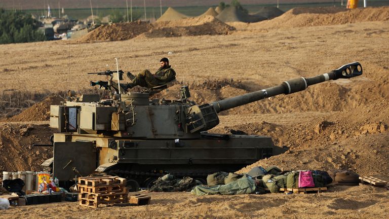 An Israeli sits on a self-propelled howitzer during the early morning near Israel&#39;s border with the Gaza Strip 