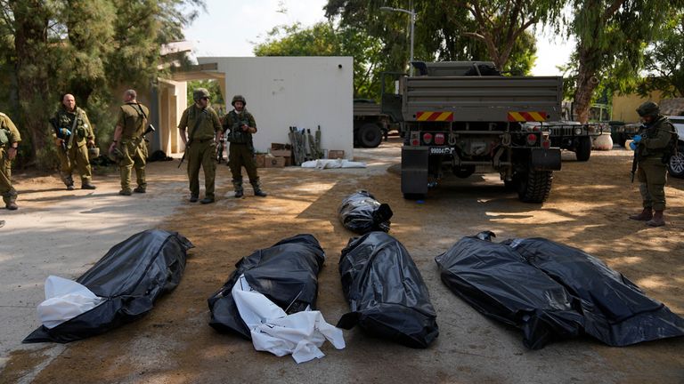 Body bags inside the Kfar Aza kibbutz. Pic: AP