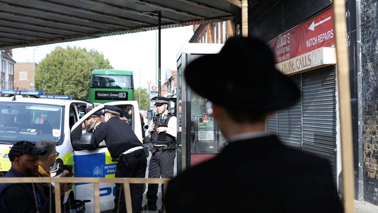 Police officers stand by a vandalised Kosher restaurant and under a bridge with &#39;Free Palestine&#39; painted on it, in Golders Green in London, Britain, October 9, 2023. REUTERS/Anna Gordon