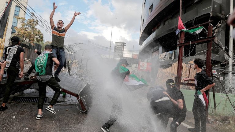 People clash with security forces during a protest near the U.S. embassy in Awkar, Lebanon, after Palestinians were killed in a blast at Al Ahli hospital in Gaza that Israeli and Palestinian officials blamed on each other