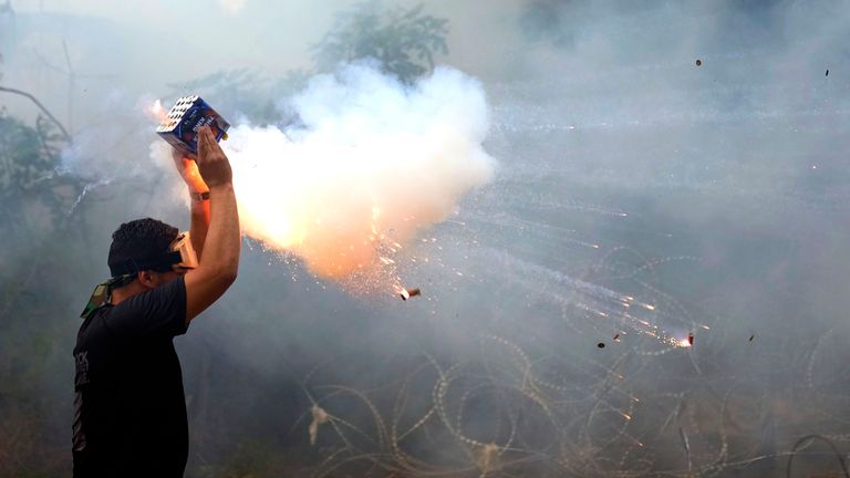 A protester launches fireworks at riot police during a demonstration, in solidarity with the Palestinian people in Gaza, near the U.S. embassy in Aukar, a northern suburb of Beirut, Lebanon
Pic:AP