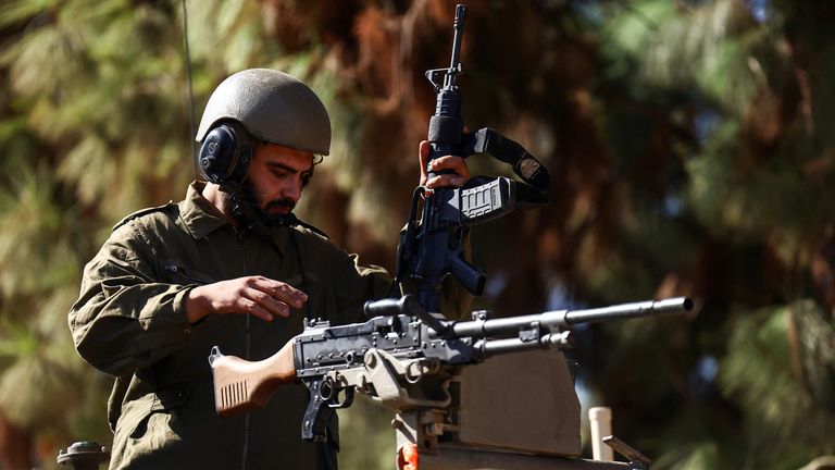 An Israeli soldier operates a firearm in an armoured vehicle near Israel&#39;s border with Lebanon, in northern Israel, October 25, 2023. REUTERS/Lisi Niesner
