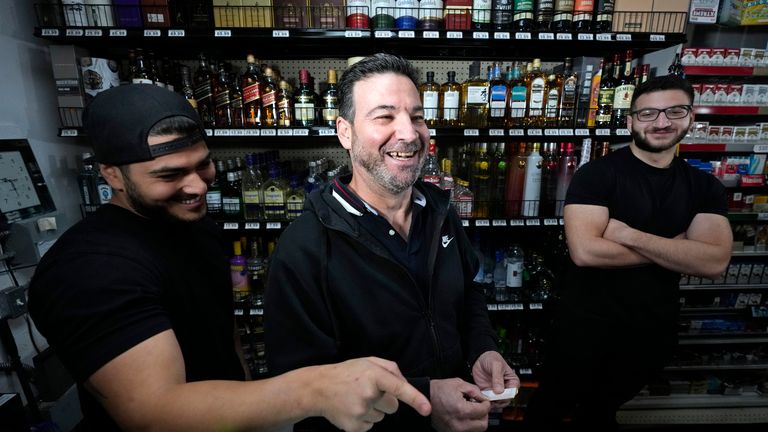 Store co-owner Nidal Khalil, center, goes over the previous day&#39;s lottery ticket sales with nephew Chris Khalil, left, and son Jonathan Khalil, right, at the Midway Market & Liquor store, Thursday, Oct. 12, 2023, in Frazier Park, Calif., where a winning Powerball lottery ticket was sold. A player in California won a $1.765 billion Powerball jackpot Wednesday night, ending a long stretch without a winner of the top prize. (AP Photo/Marcio Jose Sanchez)