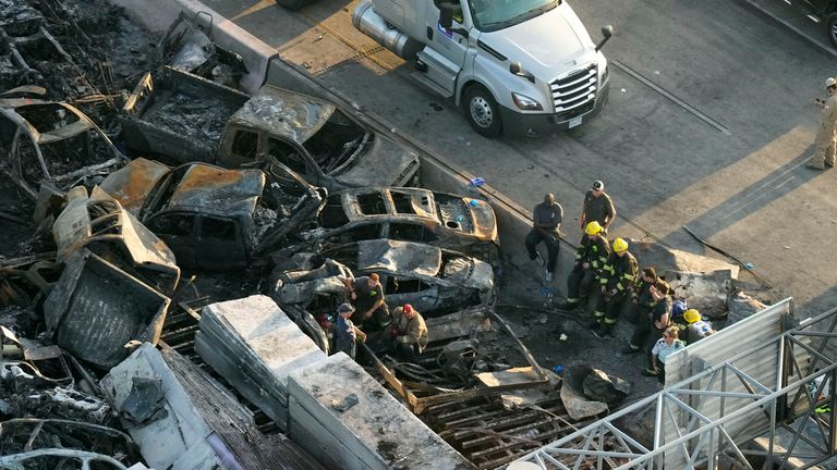 Responders near the wreckage of the pile-up. Pic: AP