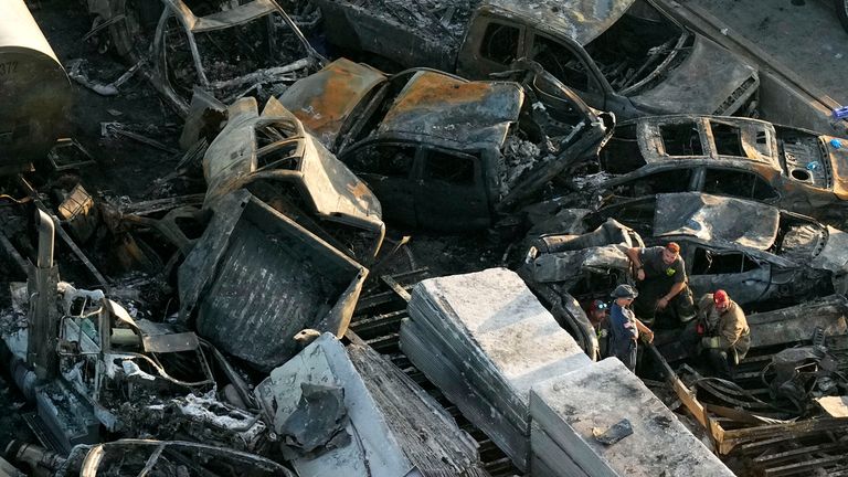 In this aerial photo, responders are seen near wreckage in the aftermath of a multi-vehicle pileup on I-55 in Manchac, La., Monday, Oct. 23, 2023. A ...superfog... of smoke from south Louisiana marsh fires and dense morning fog caused multiple traffic crashes involving scores of cars. (AP Photo/Gerald Herbert)