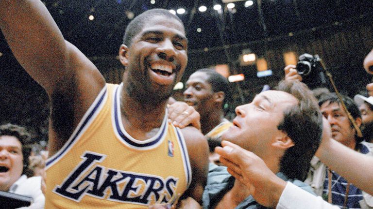 Los Angeles Lakers&#39; Magic Johnson shows his elation as he&#39;s swarmed by fans as he leaves the court after Lakers defeated Boston Celtics, 106-93, to win the NBA championship at the Forum in Inglewood, California on June 14, 1987. Johnson was named the MVP of the series. (AP Photo/Reed Saxon)