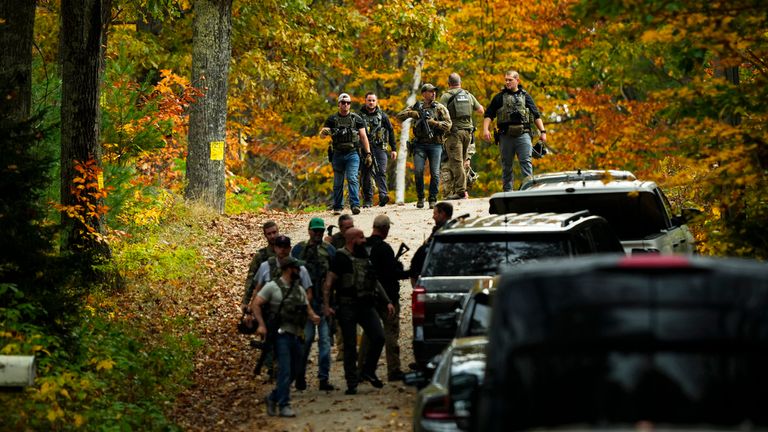 Law enforcement continue a manhunt in the aftermath of a mass shooting, in Durham, Maine, Friday, Oct. 27, 2023. Authorities are scouring hundreds of acres of family-owned property, sending dive teams to the bottom of a river and scrutinizing a possible suicide note in the second day of their intensive search for an Army reservist accused of fatally shooting several people in Maine.(AP Photo/Matt Rourke)