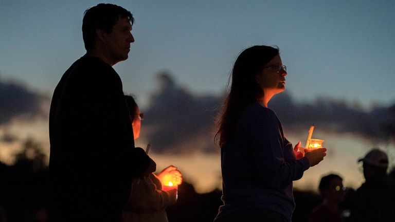 Mourners attend a candlelight vigil for the victims of this week&#39;s mass shootings, Saturday, Oct. 28, 2023, in Lisbon Falls, Maine. A gunman killed multiple people at the bowling alley and a bar in nearby Lewiston, Maine, on Wednesday. The body of suspected shooter Robert Card was found on Friday in Lisbon Falls. (AP Photo/Robert F. Bukaty)