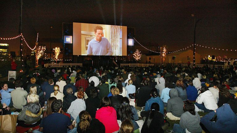 People watch the final episode of "Friends" at the Tribeca drive-in movie theatre in New York May 6, 2004. After 10 years, the "Friends" hour-long finale is expected to draw an estimated 40-50 million viewers, bidding fairwell to the TV comedy which followed the lives of six New York coffee shop regulars. REUTERS/Shannon Stapleton SS