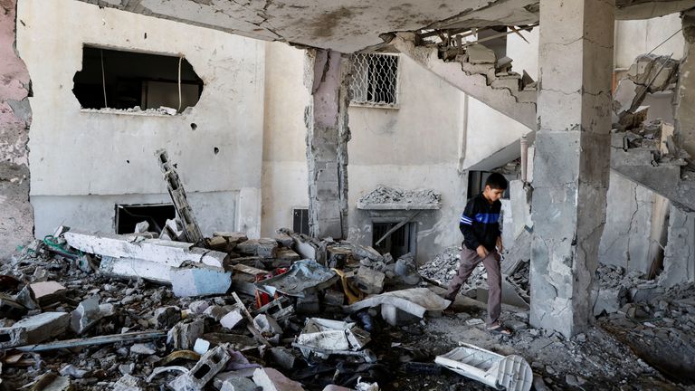 A Palestinian boy checks the damage at a mosque which was hit in an Israeli air strike, in Jenin refugee camp in the Israeli-occupied West Bank October 22, 2023. REUTERS/Raneen Sawafta