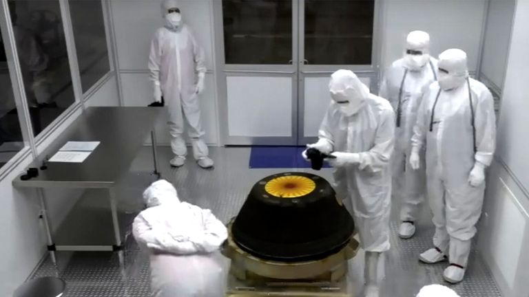 NASA technicians in a clean room examine the sample return capsule from NASA&#39;s Osiris-Rex