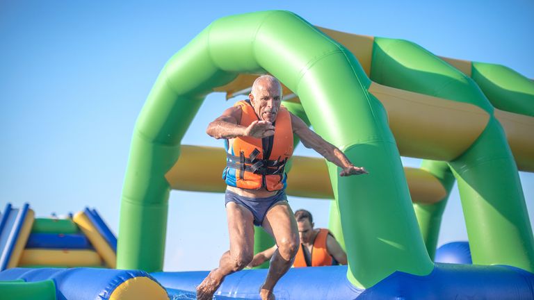 iStock image of men completing obstacle course 