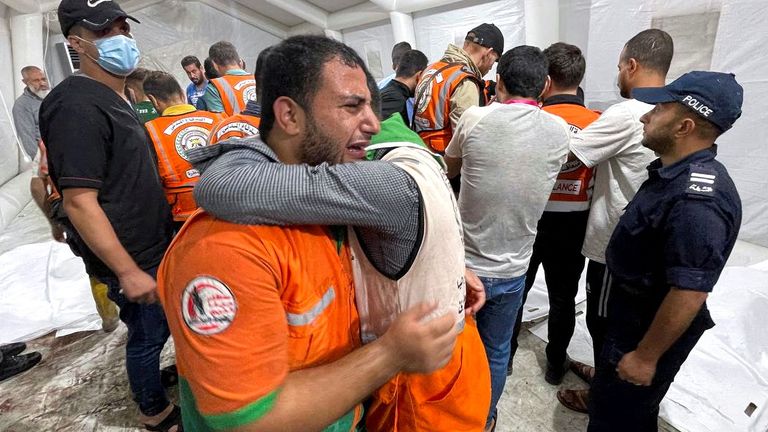 Members of a Palestinian civil emergency team react after several colleagues were killed in Israeli strikes, at Shifa Hospital in Gaza City October 16, 2023. REUTERS/Mohammed al-Masri
