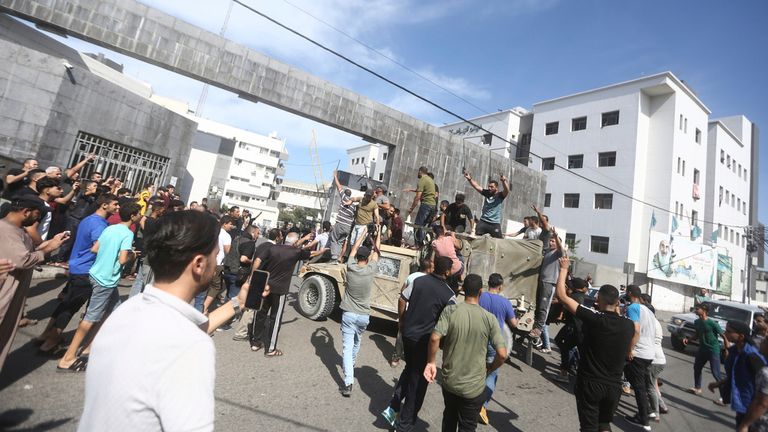 07 October 2023, Palestinian Territories, Gaza City: Palestinian take control of an Israeli military vehicle after crossing the border fence with Israel from Jabalia in the northern Gaza Strip. Palestinian militants in Gaza unexpectedly fired dozens of rockets at Israeli targets early on Saturday, the Israeli army said. Photo by: Mohammed Talatene/picture-alliance/dpa/AP Images


