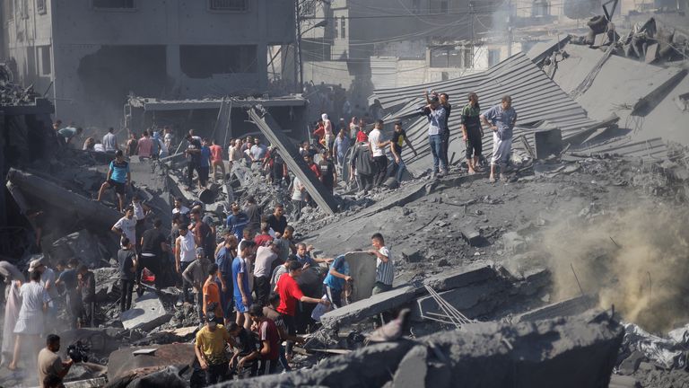 Palestinians gather at the site of Israeli strikes on houses
