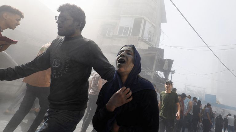 Palestinians react at the site of Israeli strikes on houses in Khan Younis in the southern Gaza Strip