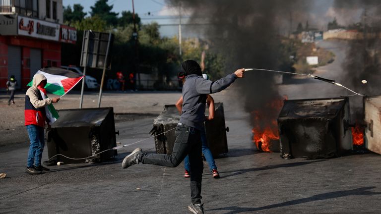 Palestinians use slings to hurl stones during clashes with Israeli forces near Ramallah in the Israeli-occupied West Bank October 18, 2023. REUTERS/Ammar Awad
