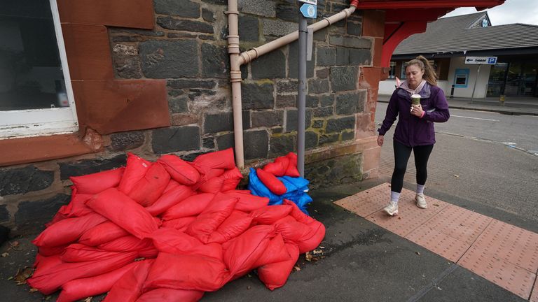 Sand bags sit piled against a wall in the main street in Aberfoyle in Perthshire. Aberfoyle was hit with flooding a couple of weeks ago as storm Babet will bring heavy rain to the UK this week, with extensive flooding expected in already-saturated parts of Scotland. The Met Office has upgraded a weather warning for rain in eastern Scotland to amber, as some areas could see more than a month&#39;s worth of rain in a few days. Picture date: Wednesday October 18, 2023.