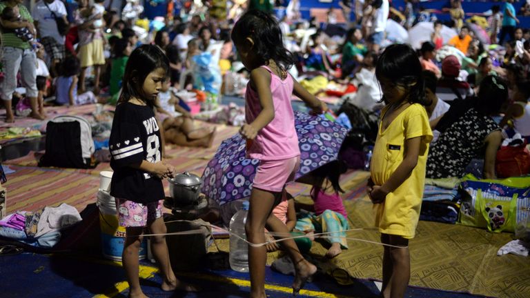 Children play at a makeshift evacuation after flash floods in Quezon City in the Philippines