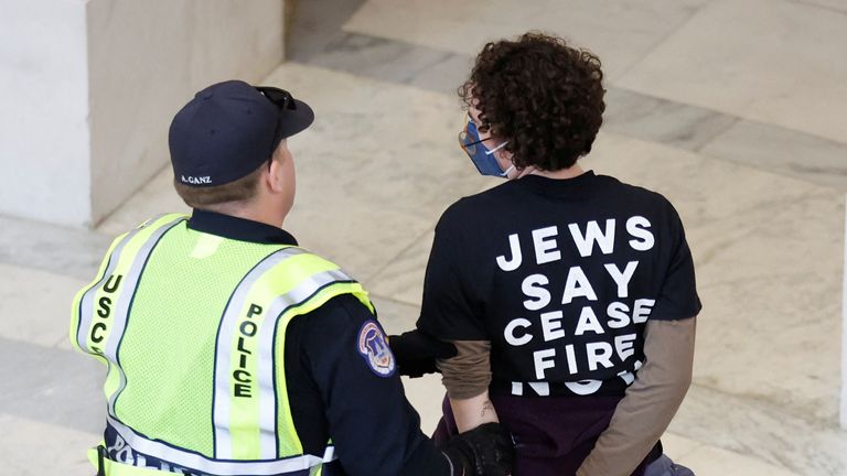 A demonstrator involved in a civil disobedience action organized by a group called "Jewish Voice for Peace" is detained by U.S. Capitol police officers during a protest calling for a cease fire in Gaza while occupying the rotunda of the Cannon House office building on Capitol Hill in Washington, U.S., October 18, 2023. REUTERS/Jonathan Ernst

