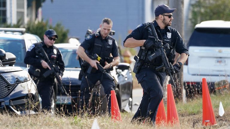 Members of law enforcement at a farm in Lisbon Falls, Maine, as the search for the suspected gunman continues