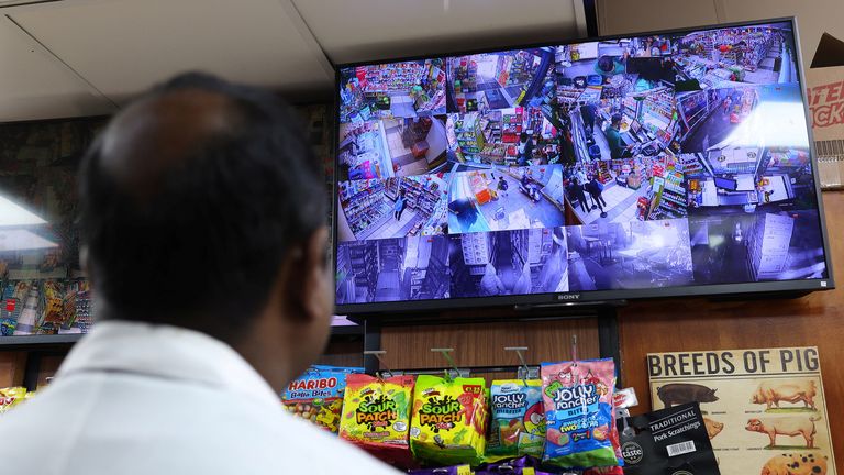 Butcher Kugan Poopalsingam views CCTV camera images at Freshfields Market food and convenience store, where he also helps with security to combat rising levels of shoplifting, in Croydon, south London, Britain, October 10, 2023. REUTERS/Toby Melville
