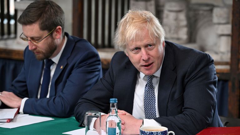 Boris Johnson flanked by cabinet secretary Simon Case in May 2022