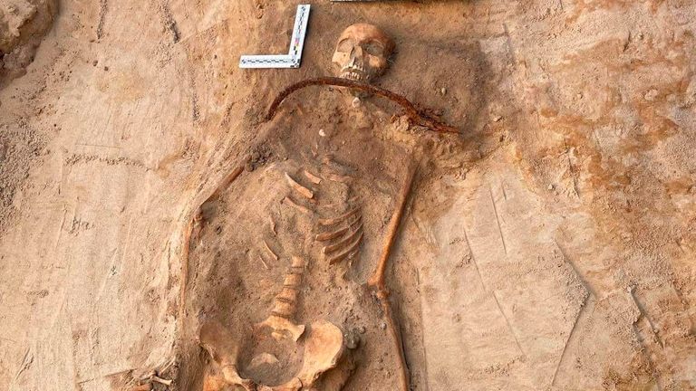 The skeleton of a young woman buried with a padlock on her foot and an iron sickle across her neck as a way of allegedly preventing her from rising from the dead