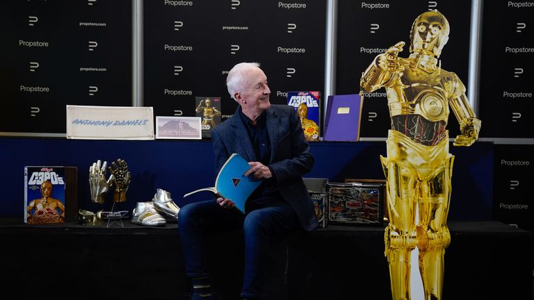 Anthony Daniels with an original third-draft script from the 1977 film &#39;Star Wars: A New Hope&#39; (estimated £10,000 - 20,000) as he poses for a photograph alongside other pieces of Star Wars memorabilia from his personal collection, during a preview for the showbiz memorabilia auction, at the Propstore in Rickmansworth, Hertfordshire. Picture date: Wednesday September 20, 2023.