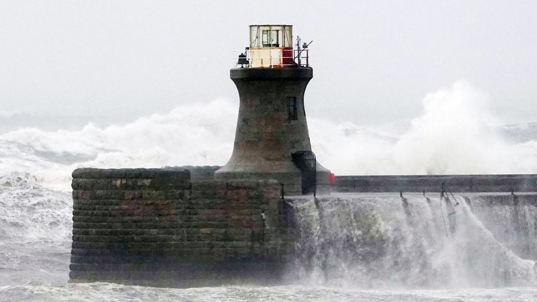 Waves crash against South Shields lighthouse after the top was ripped off as Storm Babet batters the country 