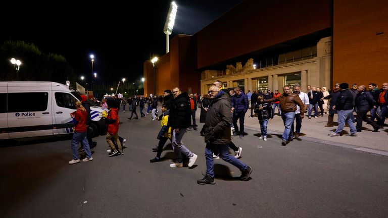 Supporters walk away from the venue after suspension of the Euro 2024 group F qualifying soccer match between Belgium and Sweden at the King Baudouin Stadium in Brussels, Monday, Oct. 16, 2023. The match was abandoned at halftime after two Swedes were killed in a shooting in central Brussels before kickoff. (AP Photo/Geert Vanden Wijngaert)
