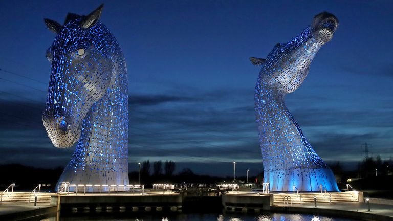 The Kelpies in Falkirk which will be lit by blue light for the remaining period of the COVID-19 crisis as a tribute to NHS and social care workers. PA Photo. Picture date: Tuesday April 7, 2020. Designed by sculptor Andy Scott each of The Kelpies, constructed of structural steel with a stainless steel outer skin, stands up to 30 metres tall and weighs over 300 tonnes. See PA story HEALTH Coronavirus. Photo credit should read: Andrew Milligan/PA Wire 