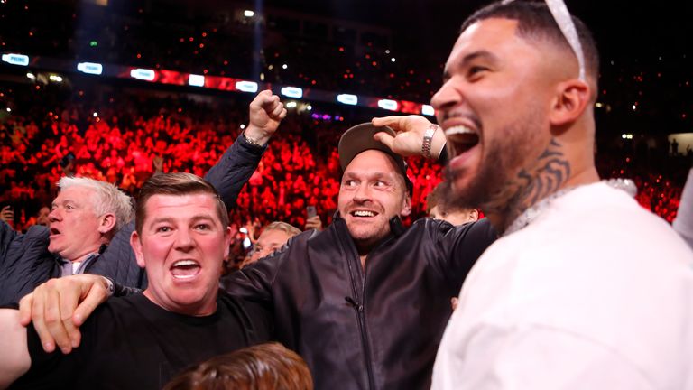 Tyson Fury (centre) celebrates his brother's victory