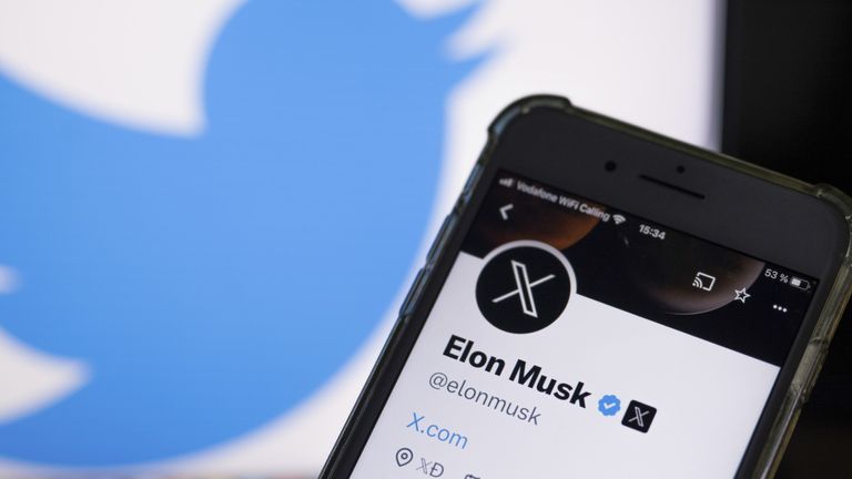 July 24, 2023, Berlin: Illustration - The official profile of Twitter owner Musk on a smartphone screen as his profile picture shows a white letter X on a black background, while the front logo of the short messaging service is displayed on the monitor background.  Musk is trying to establish X as a new name for a short messaging service.  Photo: Monika Skolimowska/picture-alliance/dpa/AP Images
