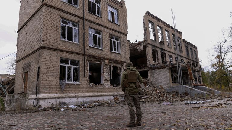 A police officer stands in front of a damaged building, amid Russia&#39;s attack on Ukraine, in the town of Avdiivka, Donetsk region