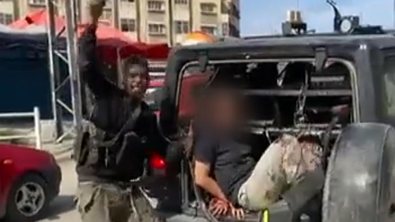 Hamas launches deadly attack on Israel with fighters on paragliders crossing border. Video posted online purportedly shows an Isreali woman being captured.