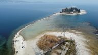 A drone image shows San Biagio island, affected by drought in Lake Garda, near Lido di Manerba, Italy. 