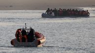 Crew members of the French rescue vessel "Abeille Normandie" look after a group of migrants on an inflatable dinghy sailing back to the Le Portel beach after their unsuccessful attempt to cross the English Channel from the coast of northern France, as warm weather and calm seas are favourable for crossings, France, October 2, 2023. REUTERS/Pascal Rossignol