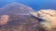 22 July 2023, Greece, Rhodos: Forest fires rage on the vacation island of Rhodes (photo taken from an airplane). According to meteorologists, the heat wave will continue next week with minor fluctuations. On Wednesday, a new peak is expected with temperatures around 46 degrees in southern Greece. Photo by: Christophe Gateau/picture-alliance/dpa/AP Images