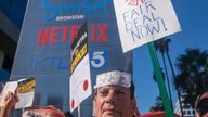 Striking SAG-AFTRA members walk with pickets outside Netflix studios, Wednesday, November 8, 2023, in Los Angeles. (Ringo Chiu via AP)