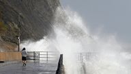 Waves crash over the harbour arm in Folkestone, Kent