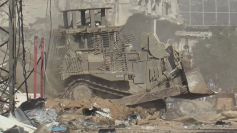 Hundreds flee on foot from the Al-Shifa hospital amid gunfire as tanks and heavy vehicles move through the area.