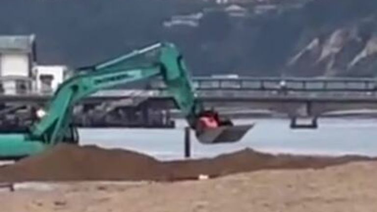 Driver rescued by digger on beach