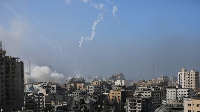 Israeli forces drop smoke bombs, amid the ongoing conflict between Israel and Palestinian Islamist group Hamas, in Gaza City