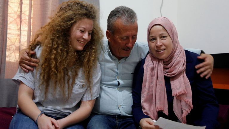 FILE PHOTO: Palestinian teenager Ahed Tamimi sits next to her father and her mother Nareman, who was released with her from an Israeli prison on Sunday, at their family house in Nabi Saleh village in the Israeli-occupied West Bank July 30, 2018. REUTERS/Raneen Sawafta/File Photo
